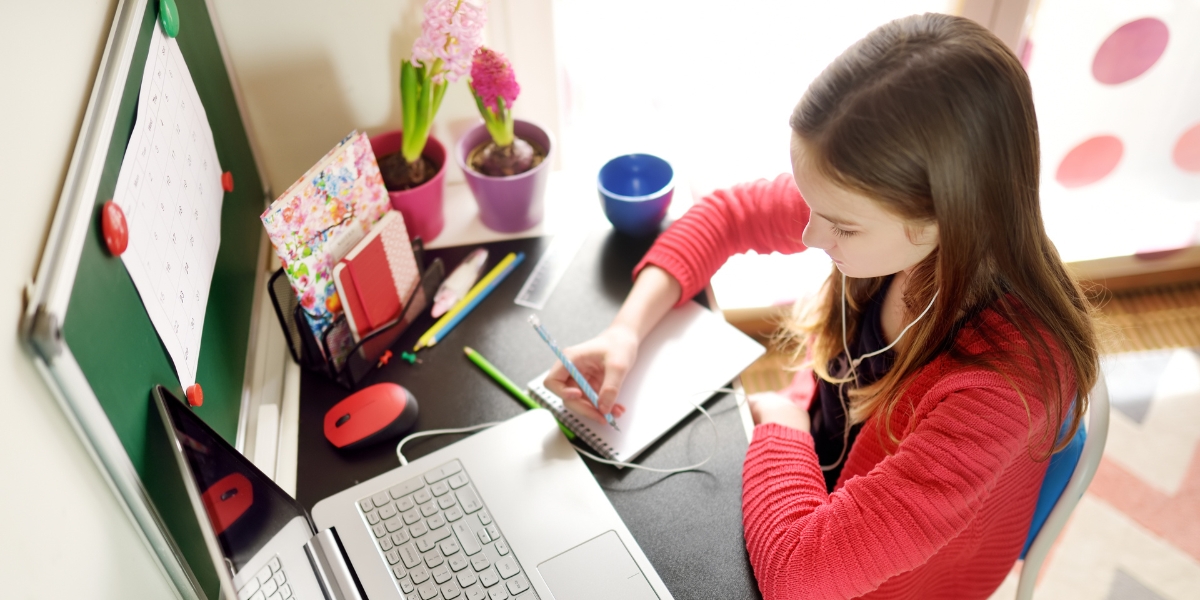 A pre teen doing homework using a computer